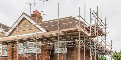 Scaffolding to red brick residential building